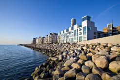 Apartments located next to the water. Boulders works as protection against the waves. Photo