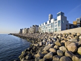 Apartments located next to the water. Boulders works as protection against the waves. Photo