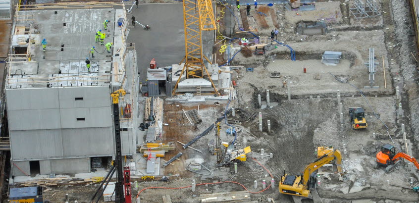 Overview of a construction site where different soil and foundation works are carried out. Construction workers and machinery at work. Photo